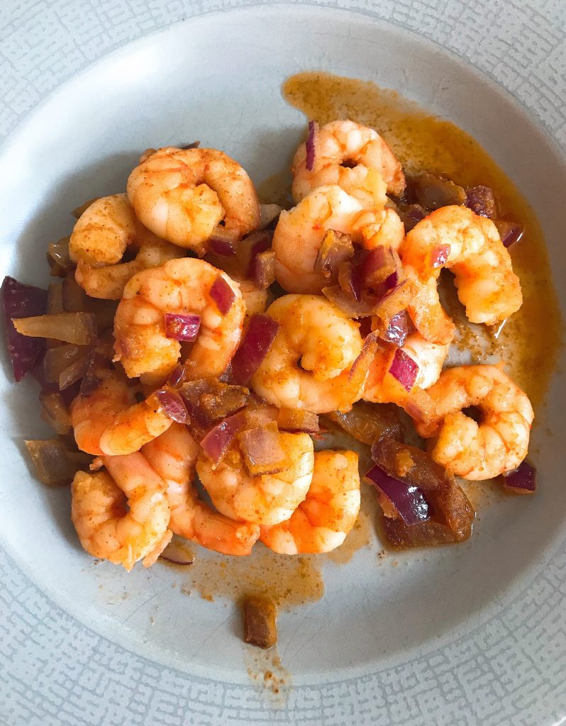 spanish garlic prawns cooked and served in a white bowl